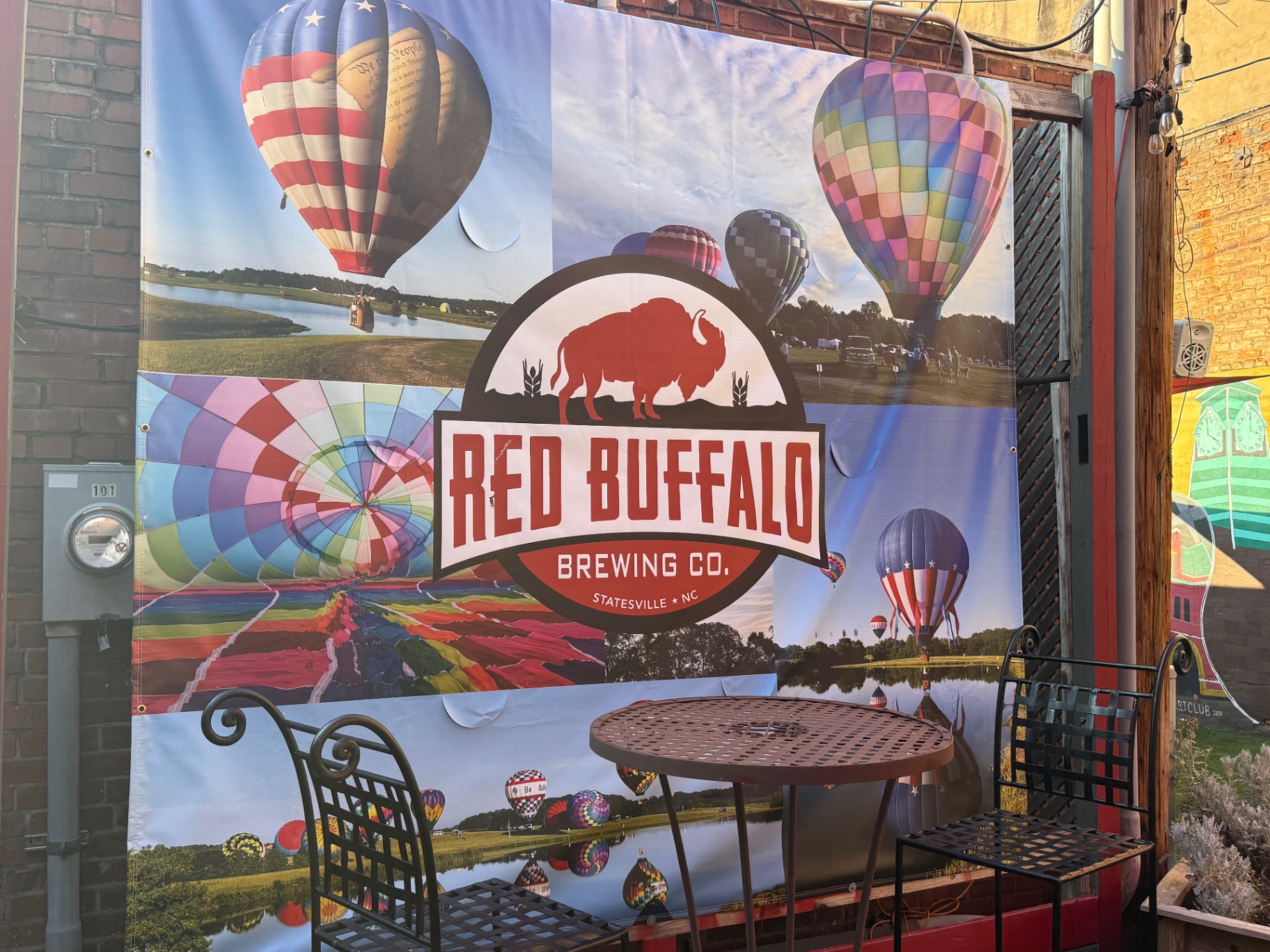 Red Buffalo Brewing Co. outdoor banner with hot air balloons in downtown Statesville